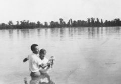 William Branham baptizing a woman in the Ohio River.